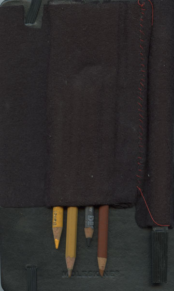 Back of sketchbook 31: a dark felt pencil roll stitched in red over a black Moleskine, four worn pencils tucked in the bottom