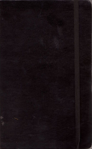 Cover of sketchbook 31: a plain black Moleskine with its elastic band, scuffed from travel